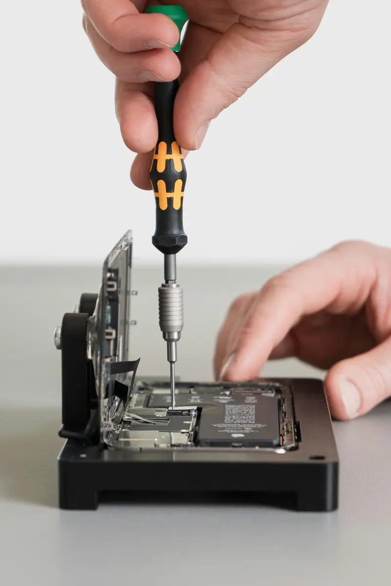Precision screwdriver on an opened phone